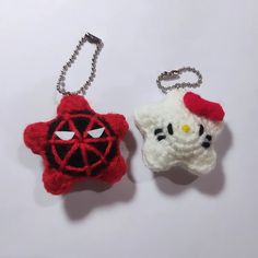 two hello kitty keychains are shown on a white surface, one is red and the other is black