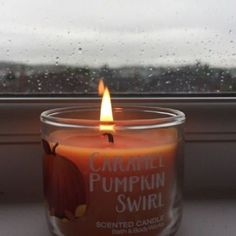 a candle that is sitting on a window sill