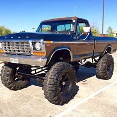 a brown and black truck parked in a parking lot