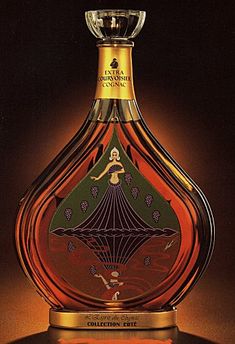 a bottle of liquor with an artistic design on the top and bottom, in front of a black background