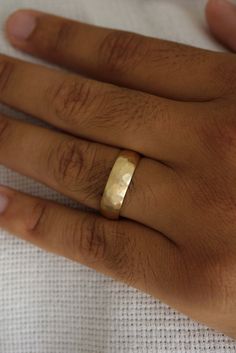 This comfort fit hammered gold wedding band features a rugged yet refined design, showcasing a textured surface that reflects light from every angle. Custom made to order. Please allow 2-3 weeks for delivery. 14k Gold Hammered Thick Band Ring, 14k Gold Hammered Wide Band Ring, Hammered Thick Band For Anniversary, Classic Hammered Wide Band Ring For Anniversary, Hammered 14k Gold Wide Band Wedding Ring, Wedding 14k Gold Wide Band Ring With Hammered Detail, 14k Gold Hammered Wide Band Ring For Wedding, Anniversary 14k Gold Hammered Wide Band Ring, Hammered Gold Wedding Band