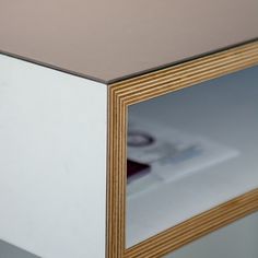 a close up view of a white and wood table