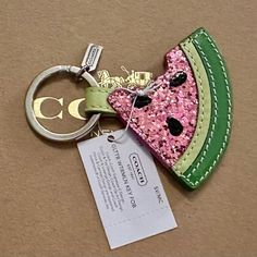 a key chain with a watermelon slice on it and a tag attached to it