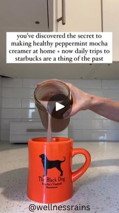 a person pouring something into a coffee mug