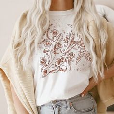 *Boho Deer Skull Flowers T-shirt, Animal Skull Grunge Shirt, Dark Academia Light Academia aesthetic clothing, Western Style Cowgirl Shirt* UNISEX T-shirt Thank you for visiting Giftables by Tati - Designed! Where only the BEST quality, softest apparel can be found! This t-shirt is everything you've dreamed of and more. It feels soft and lightweight, with the right amount of stretch. It's comfortable and flattering for all. DETAILS: Shirts are UNISEX FIT. Please size down 1 size for a better fit. White Hippie Crew Neck T-shirt, White Crew Neck Hippie T-shirt, White Bohemian Shirt With Graphic Print, Bohemian White Shirt With Graphic Print, White Bohemian Shirt With Crew Neck, White Bohemian Crew Neck Shirt, White Crew Neck Hippie Top, White Bohemian Top With Screen Print, Deer Skull Flowers