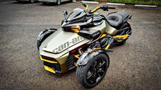 a yellow and black motorcycle parked in a parking lot