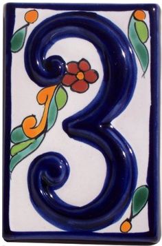 the number three is painted in blue and orange with flowers on it's sides