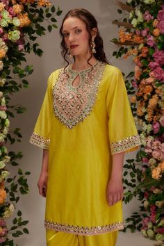 Yellow short a-line kurta featuring gota, sequin and moti work on the neckline and hem. Paired with a draped samosa dhoti pant and a blush pink organza dupatta. - Aza Fashions Summer Party Kurta With Gota Work, Summer Festive Anarkali Set With Gota Work, Designer Dori Work Palazzo Set For Summer, Elegant Multicolor Kurta With Mirror Work, Designer Summer Palazzo Set With Dori Work, Summer Festive Sharara With Dori Work, Summer Festive Palazzo Set With Gota Work, Summer Festive Palazzo Set With Dori Work, Summer Festive Traditional Wear With Gota Work