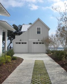 a white house with two garages on the side