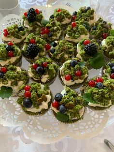 a white plate topped with cupcakes covered in toppings