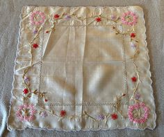 This is a charming, vintage semi-sheer silk handkerchief. Hand embroidered with purple, pink & red flowers. It is off white with a stitched, scalloped edge.  This hanky is in good, vintage condition. Shows a small water mark & smudge in the center. No other soil, damage or stains.  Sweet. Pink Red Flowers, Silk Handkerchief, Water Mark, Vintage Handkerchiefs, Semi Transparent, Scalloped Edge, Red Flowers, Pink Red, Hand Embroidered