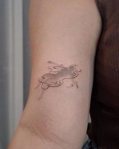 a woman's arm with a small tattoo on the left side of her arm