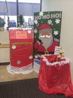 two red boxes with santa clause decorations on them and a sign that says ho ho hoo