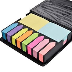 an open black case filled with assorted colored sticky notes on top of each other