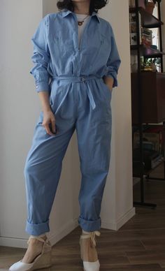 Vintage 70s work jumpsuit overall. Long front zip, two large pockets on the bust, belt with metal straps at the waist, side pockets. Metal snap buttons on the cuffs. Very long trousers, to be rolled up or shortened. Light blue, 100% cotton. Made in Italy. Excellent vintage conditions. Unisex Signed size 46 italian (14 uk). Best fit from size 10 uk (oversize) to 14 uk. Model's size 8 uk, h 163 cm. Light Blue Overall Jumpsuits With Pockets, Light Blue Overall Jumpsuits And Rompers With Pockets, Vintage Spring Workwear Overalls, Cotton Overalls With Belt Loops For Work, Utility Cotton Denim Jumpsuit With Belt Loops, Utility Style Cotton Denim Jumpsuit With Belt Loops, Light Blue Cotton Jumpsuit With Pockets, Light Blue Cotton Jumpsuits And Rompers With Pockets, Vintage Blue Jumpsuits And Rompers For Workwear