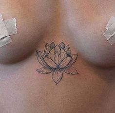 a woman's breast with a flower tattoo on it