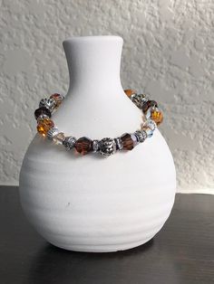 This beautiful bracelet is made with Swarovski And Czech Crystal's (smoky and brown tones with gold colored accents). It also has two different silver beads and a silver toggle closure. I can change it to a lobster clasp or a stretch bracelet if you like, just let me know! Brown Bracelet With Silver Beads, Brown Silver Beads Bracelet Jewelry, Brown Silver Beaded Bracelet, Brown Faceted Bead Bracelet, Elegant Brown Jewelry With Silver Beads, Brown Crystal Bracelet With Faceted Round Beads, Brown Bracelets With Silver Round Beads, Brown Crystal Bracelet With Faceted Beads For Gift, Brown Crystal Bracelet With Faceted Beads As Gift