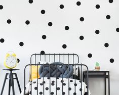 a black and white polka dot wall decal in a child's bed room