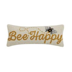 a pillow with the words bee happy on it