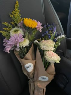 flowers are wrapped in brown paper and placed on the back seat of a car, ready to be picked up