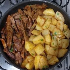 the meal is prepared and ready to be eaten on the stove top, with meat and potatoes in it