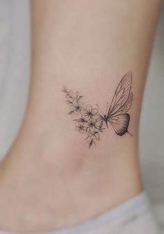 a small tattoo on the ankle of a woman's foot with a butterfly and flower