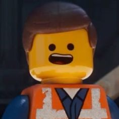 the lego movie character is wearing an orange vest and blue shirt with white letters on it