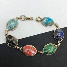 195.00 USD 1960's Lucite Bracelet, chunky mid century jewelry 1950s 1960s Collectible Accessories Just love this bracelet that is in very good vintage condition. Has a really nice look to it. Very nice addition to any collectible mid century collection. For more purses.... https://www.etsy.com/shop/MartiniMermaid?ref=listing-shop2-all-items-count§ion_id=8097288 For more bracelets ...... https://www.etsy.com/shop/MartiniMermaid?ref=hdr_shop_menu§ion_id=8097311 For more vintage… Vintage Natural Stone Bracelet, Retro Oval Cabochon Jewelry, Mid-century Style Adjustable Bracelets As A Gift, Vintage Adjustable Stretch Bracelet, Vintage Multicolor Oval Jewelry, Vintage Cabochon Bracelets, Vintage Multicolor Cabochon Jewelry, Vintage Blue Oval Bracelets, Vintage Blue Oval Bracelet