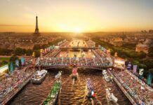 an aerial view of boats in the water at sunset