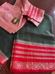 This is a beautiful Light weight warm silk saree with designer stitched blouse. This saree is hand woven. This saree would be worn for almost any occasion. Color of the saree is dark green with bright red border bright red weaving with all over floral thread weaving. Blouse is perfectly stitched and designed and can fit to size 36-44inches Chest. Ships immediately. Anarkali Blouse Piece With Border In Tussar Silk, Anarkali Tussar Silk Blouse Piece With Border, Semi-stitched Cotton Silk Blouse Piece With Border, Traditional Handloom Tussar Silk Blouse, Cotton Silk Blouse Piece With Traditional Drape, Bollywood Style Blouse Piece With Border In Cotton Silk, Bollywood Style Cotton Silk Blouse Piece With Border, Traditional Drape Cotton Silk Blouse With Border, Navratri Tussar Silk Blouse Piece With Border