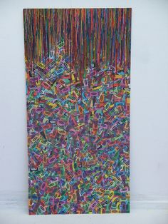 an abstract painting with multicolored lines and fringes hanging on the side of a wall