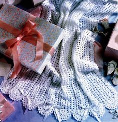 two wrapped presents sitting on top of a blanket