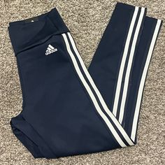 Navy Leggings With White Stripes Aero Ready 89% Polyester 11% Spandex High Rise 7/8 Style Stretch Gym Pants With Three Stripes, Stretch Sports Bottoms With Three Stripes Branding, Adidas Stretch Moisture-wicking Pants, Fitted Sports Pants With Three Stripes, Stretch Athleisure Leggings With Three Stripes, Fitted Three Stripes Sports Pants, Adidas Activewear With Stretch And Three Stripes, Adidas Activewear With Three Stripes And Stretch Fit, Adidas Stretch Activewear With Three Stripes Branding