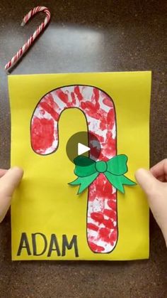 someone is making a candy cane made out of paper