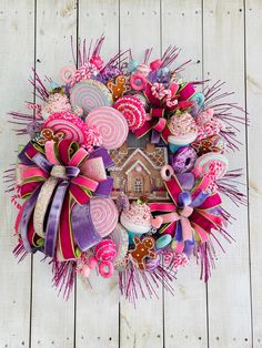 a wreath made out of candy and lollipops on top of a wooden table