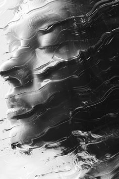 a black and white photo of a woman's face with water droplets on it