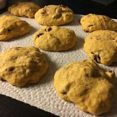 nine cookies are on a towel next to a cup