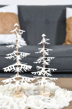 a white christmas tree sitting on top of a wooden table