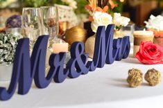 the table is set with candles, flowers and wine glasses for an elegant wedding reception