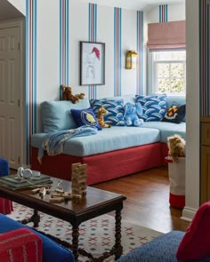 a living room with blue and red striped walls