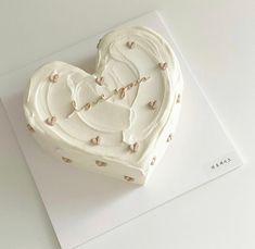 a heart shaped cake sitting on top of a card