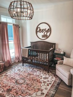 a baby's room with a crib, chair and rug