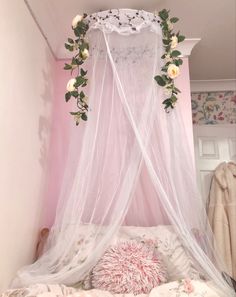 a white canopy bed with flowers on it