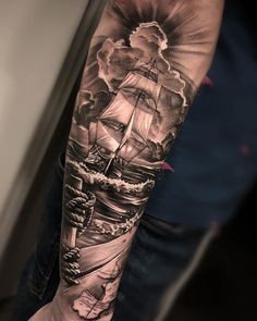 a man's arm with a ship on it