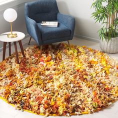 a living room with a rug made out of leaves and a chair in the corner