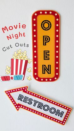 two magnets that say movie night cut outs rest room and popcorn on the wall