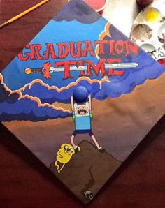 a graduation cap with an image of spongebob on it and the words graduation time painted on it