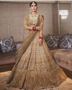 a woman in a bridal gown posing for the camera