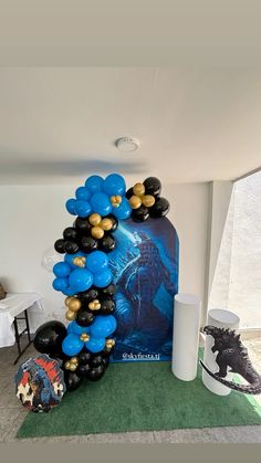 balloons are stacked on top of each other in the shape of an arch at a party