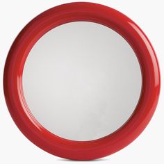 a red frisbee sitting on top of a white table next to a mirror